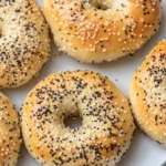 Cottage Cheese Bagels Made Easy: High-Protein & Quick 2 Homemade cottage cheese bagels with everything seasoning on a white plate