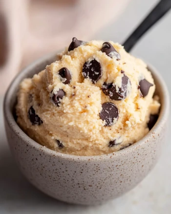 Scoop of Cottage Cheese Cookie Dough Scoop of cottage cheese cookie dough with chocolate chips in a ceramic bowl
