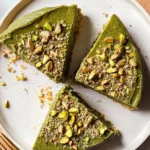 Easy Pistachio Cottage Cheese Cheesecake (High Protein, No Refined Sugar) 2 Top view of sliced pistachio cottage cheese cheesecake topped with crushed and whole pistachios