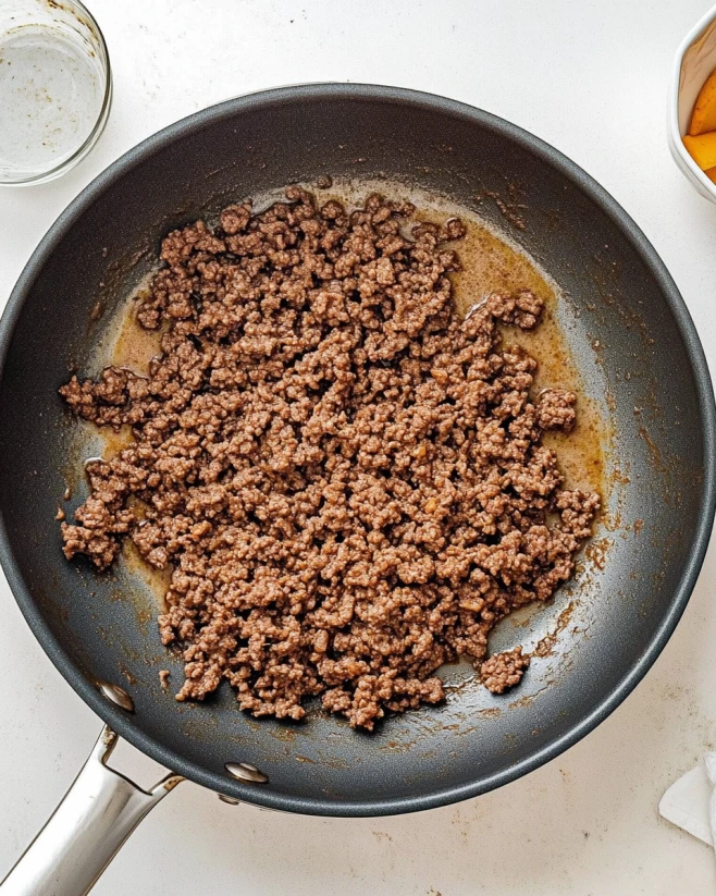 ground-beef-cooked-for-beef-sweet-potato-cottage-cheese-bowl Seasoned ground beef browning in a non-stick skillet for beef sweet potato cottage cheese bowl